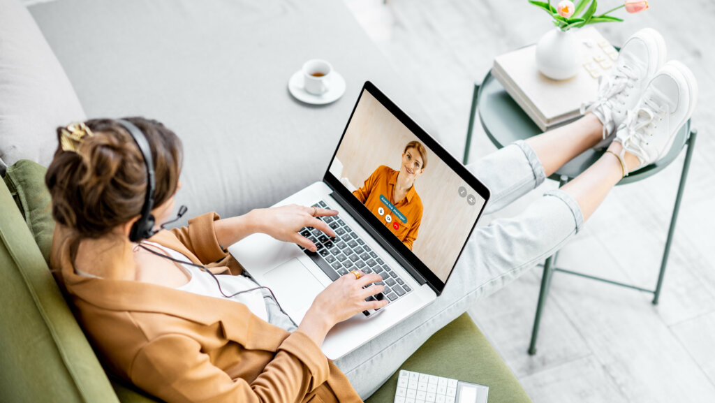 Business woman having a video call with coworker, working online from home at cozy atmosphere. Concept of remote work from home